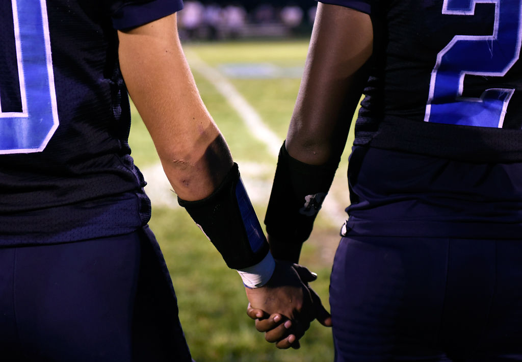 Tolton teammates Nick Beckett and Eyob Teklesenbet hold hands